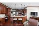 Spacious kitchen features custom wood cabinets, granite countertops, stainless appliances, and a breakfast bar with seating at 7126 Nile Ridge Ct, Indianapolis, IN 46236