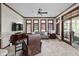 Cozy living room with carpet flooring, wood trim, ceiling fan, and large windows for natural light at 7126 Nile Ridge Ct, Indianapolis, IN 46236