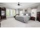Serene main bedroom features a large window, soft carpet, ceiling fan and neutral décor at 7126 Nile Ridge Ct, Indianapolis, IN 46236