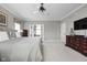 Spacious main bedroom featuring soft carpet, neutral decor, and a sitting area overlooking a french doors at 7126 Nile Ridge Ct, Indianapolis, IN 46236