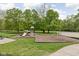 A large playground is surrounded by green grass and mature trees on a sunny day at 7126 Nile Ridge Ct, Indianapolis, IN 46236