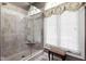 New bathroom tiled shower featuring glass enclosure and window with decorative valance at 7126 Nile Ridge Ct, Indianapolis, IN 46236