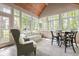 Bright sunroom with vaulted ceiling, many windows, and a casual seating area for relaxation at 7126 Nile Ridge Ct, Indianapolis, IN 46236