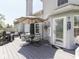 Entertain on this home's back deck that features an outdoor dining area with comfortable seating under a large umbrella at 7203 Sycamore Run Dr, Indianapolis, IN 46237