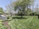 Enjoy the shade of mature trees in this grassy backyard, complete with a playset and room to run and play at 7203 Sycamore Run Dr, Indianapolis, IN 46237