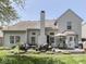 Relax or entertain on the back deck in this private backyard with an outdoor dining area, fireplace and mature landscaping at 7203 Sycamore Run Dr, Indianapolis, IN 46237