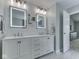 Bathroom featuring dual sinks, modern lighting, and ample counter space at 7203 Sycamore Run Dr, Indianapolis, IN 46237