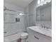Modern bathroom featuring a shower with herringbone tile surround, toilet, and vanity with marble countertop at 7203 Sycamore Run Dr, Indianapolis, IN 46237