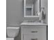 Charming bathroom vanity with white cabinets, marble countertop, chrome hardware and a decorative mirror at 7203 Sycamore Run Dr, Indianapolis, IN 46237