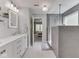 Bright bathroom featuring dual sinks, tile floors, and a glass-enclosed shower at 7203 Sycamore Run Dr, Indianapolis, IN 46237