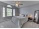 Cozy bedroom with a ceiling fan, large window, and neutral colors, creating a calm and inviting space at 7203 Sycamore Run Dr, Indianapolis, IN 46237