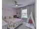 Light filled bedroom with pink and gray accents, including a play tent, inviting ' room at 7203 Sycamore Run Dr, Indianapolis, IN 46237