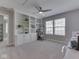 Bedroom featuring built-in shelves and cabinets, a ceiling fan, and natural light from large windows at 7203 Sycamore Run Dr, Indianapolis, IN 46237