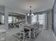 Cozy dining room with a table set for six, adjacent to the well-lit living area at 7203 Sycamore Run Dr, Indianapolis, IN 46237