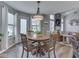 Cozy dining area with a round table, adjacent to the living room and outdoor access at 7203 Sycamore Run Dr, Indianapolis, IN 46237