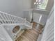 Elevated view of the foyer with wood floors, a staircase, and a stylish entry table at 7203 Sycamore Run Dr, Indianapolis, IN 46237