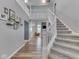 Spacious entryway featuring staircase with carpet runner and views into the living areas at 7203 Sycamore Run Dr, Indianapolis, IN 46237