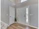 Bright foyer showcasing hardwood floors, a coat closet, and modern decor with plenty of natural light at 7203 Sycamore Run Dr, Indianapolis, IN 46237