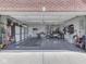 Spacious three-car garage includes epoxy flooring, storage cabinets, and plenty of room for a golf cart at 7203 Sycamore Run Dr, Indianapolis, IN 46237