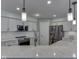 Bright kitchen with stainless steel appliances, white cabinets, quartz countertops, and modern pendant lighting at 7203 Sycamore Run Dr, Indianapolis, IN 46237