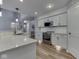 Modern kitchen featuring stainless steel appliances, white cabinets, subway tile backsplash, and quartz countertops at 7203 Sycamore Run Dr, Indianapolis, IN 46237