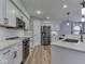 Modern kitchen with white cabinets, stainless steel appliances, and sleek countertops at 7203 Sycamore Run Dr, Indianapolis, IN 46237