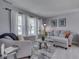 Cozy living room showcasing neutral color palette, plush seating, and large windows with lots of light at 7203 Sycamore Run Dr, Indianapolis, IN 46237