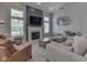 Inviting living room boasts a fireplace with a TV, large windows, and comfortable seating at 7203 Sycamore Run Dr, Indianapolis, IN 46237