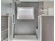 Modern tiled shower with a rainfall showerhead, window, and built-in shelving at 7203 Sycamore Run Dr, Indianapolis, IN 46237