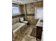 Bathroom features tiled walls, a bath tub, toilet, window, and vanity with sink at 725 E New York E St, Indianapolis, IN 46202