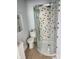 Small bathroom featuring a curved shower with tile and a toilet next to a vanity and mirror at 725 E New York E St, Indianapolis, IN 46202