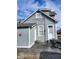 Rear exterior view of a grey home with a patio and outdoor seating area at 725 E New York E St, Indianapolis, IN 46202