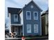 Charming two-story home with gray siding and white trim, featuring a covered porch and a classic architectural design at 725 E New York E St, Indianapolis, IN 46202