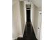 Hallway with wooden floors runs along neutral colored walls, leading to another room at 725 E New York E St, Indianapolis, IN 46202