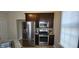 Kitchen featuring stainless steel appliances, dark wood cabinets, and tile flooring at 725 E New York E St, Indianapolis, IN 46202