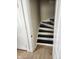 Staircase with white risers and a dark stained tread, with a white trim and light walls at 725 E New York E St, Indianapolis, IN 46202