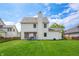 Spacious backyard featuring a pergola with outdoor seating, lush lawn, and mature trees at 7319 Hartington Pl, Indianapolis, IN 46259