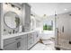 Spacious bathroom with double vanity, freestanding tub, glass shower, and modern finishes at 7319 Hartington Pl, Indianapolis, IN 46259