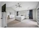 Bright bedroom featuring a ceiling fan, carpet, and neutral decor at 7319 Hartington Pl, Indianapolis, IN 46259