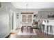 Cozy dining area adjacent to kitchen, featuring a table set for four and lots of natural light at 7319 Hartington Pl, Indianapolis, IN 46259