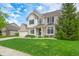 Beautiful two-story home featuring a well-maintained lawn and manicured landscaping at 7319 Hartington Pl, Indianapolis, IN 46259