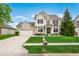 Charming two-story home with a well-manicured lawn, a two car garage and neutral brick and siding at 7319 Hartington Pl, Indianapolis, IN 46259