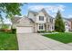 Charming two-story home with a two car garage, extended drive and neutral brick and siding at 7319 Hartington Pl, Indianapolis, IN 46259
