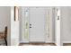 Bright foyer with white front door, sidelights, and wood floors at 7319 Hartington Pl, Indianapolis, IN 46259