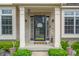Welcoming front porch with black door and decorative details, flanked by windows at 7319 Hartington Pl, Indianapolis, IN 46259