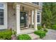 Welcoming front porch with black door and decorative details at 7319 Hartington Pl, Indianapolis, IN 46259