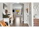 Hallway featuring wood floors and view of the living room at 7319 Hartington Pl, Indianapolis, IN 46259