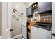 Convenient laundry room with modern washer and dryer, custom cabinets, and decorative accents at 7319 Hartington Pl, Indianapolis, IN 46259