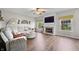 Bright living room features a fireplace, large sectional sofa and big windows letting in lots of natural light at 7319 Hartington Pl, Indianapolis, IN 46259
