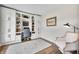 Bright office space with custom built-ins, a desk, and a comfortable chair on a soft, patterned rug at 7319 Hartington Pl, Indianapolis, IN 46259